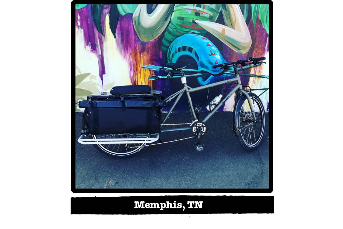 Right side view of a Surly Big Dummy bike in front of a wall with a colorful mural - Memphis, TN tag below image