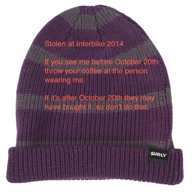Surly Wool Beanie - purple & grey horizontal stripes - text typed over the image - laying flat with a white background
