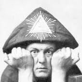 Headshot of a person wearing a cone shaped hat, with their hands pressing against their checks - black & white image