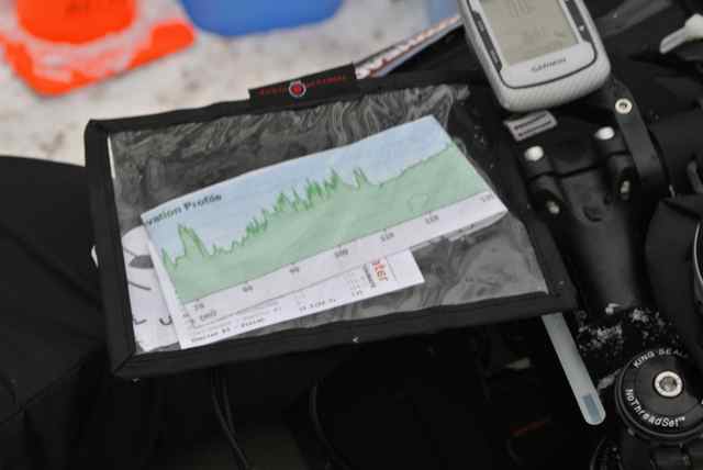 Close up, downward view of a terrain map, on a pack above the handlebar of a bike