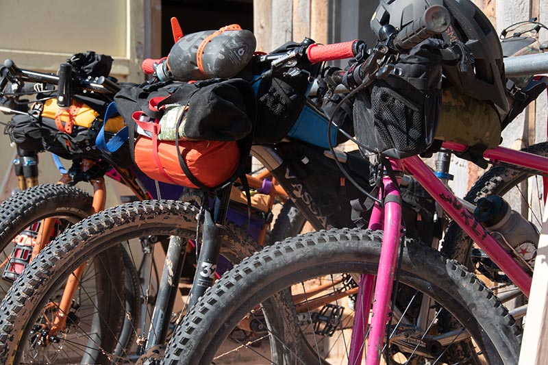 Four mountain bikes parked loaded with bikepacking bags