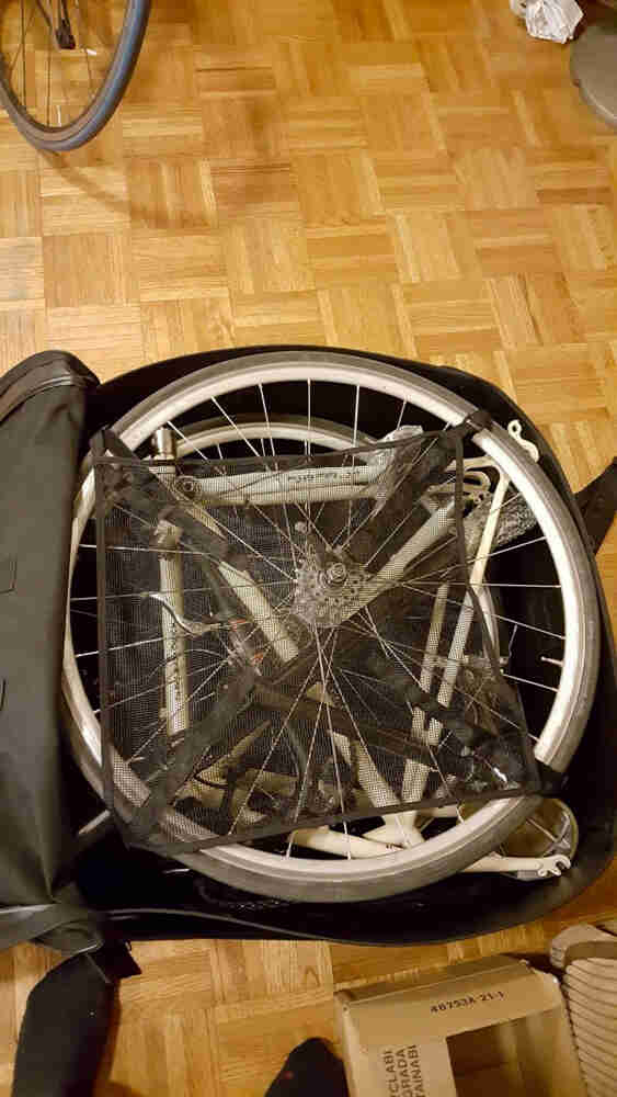 Downward view of a disassembled bike, packed inside of a travel bag
