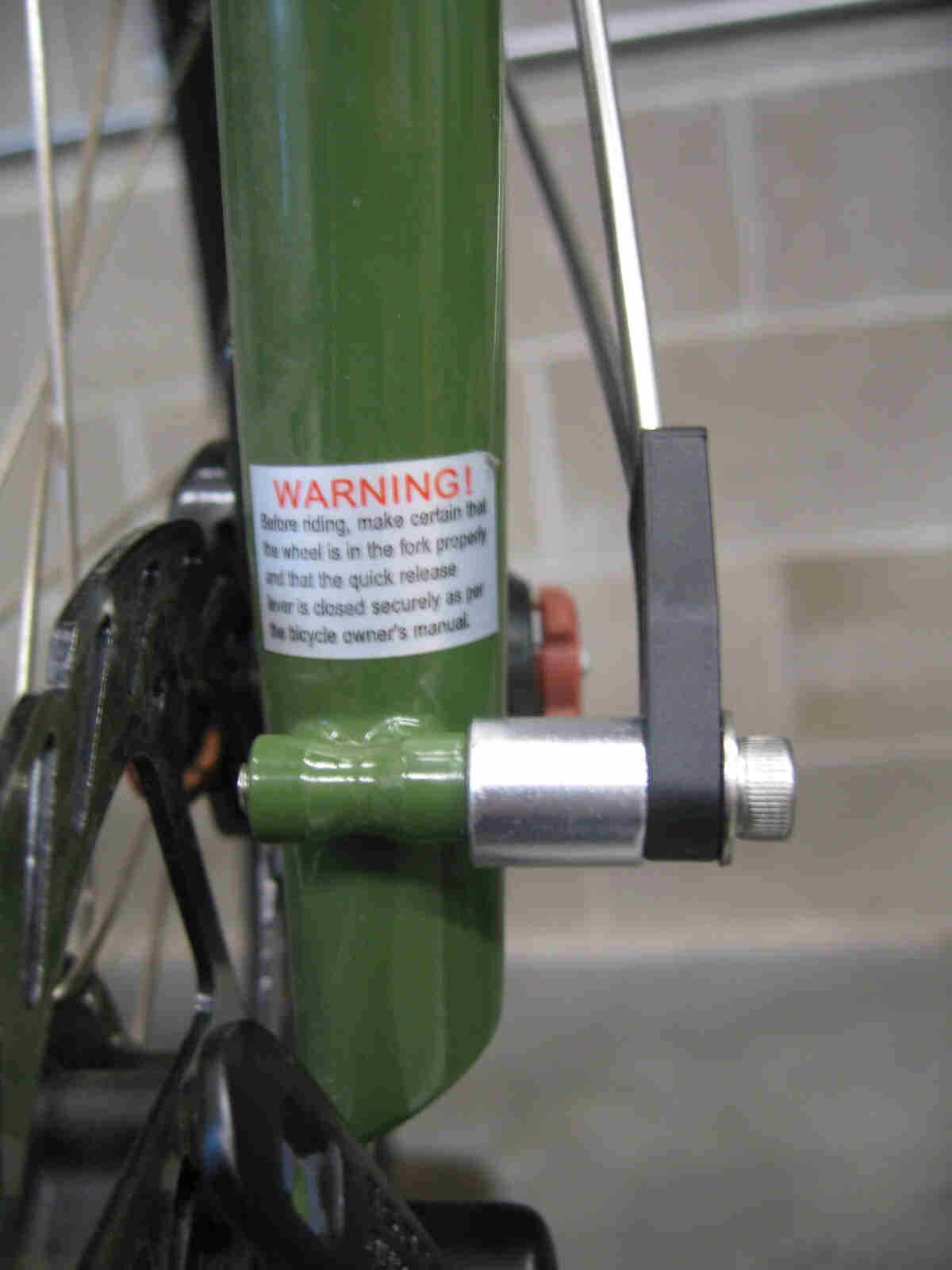 Surly Ogre bike - green - fork, front fender spacer nut detail - front, left side, close up view