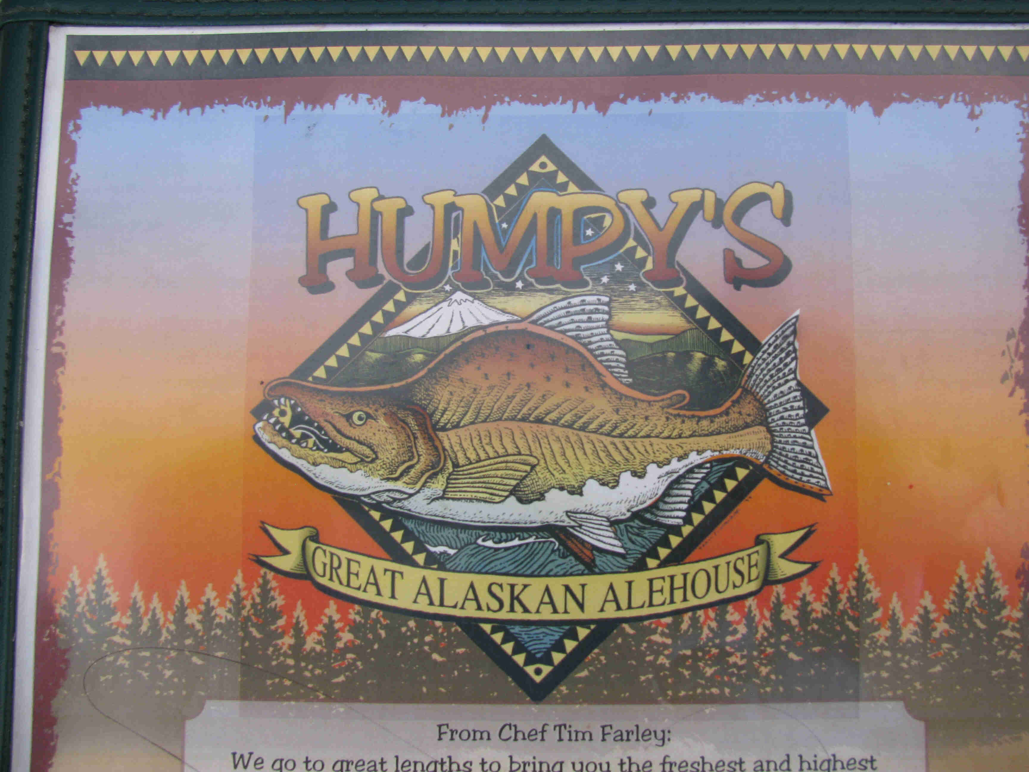 Downward front view of a menu cover for Humpy's Great Alaskan Ale House, with a colored fish illustration on it