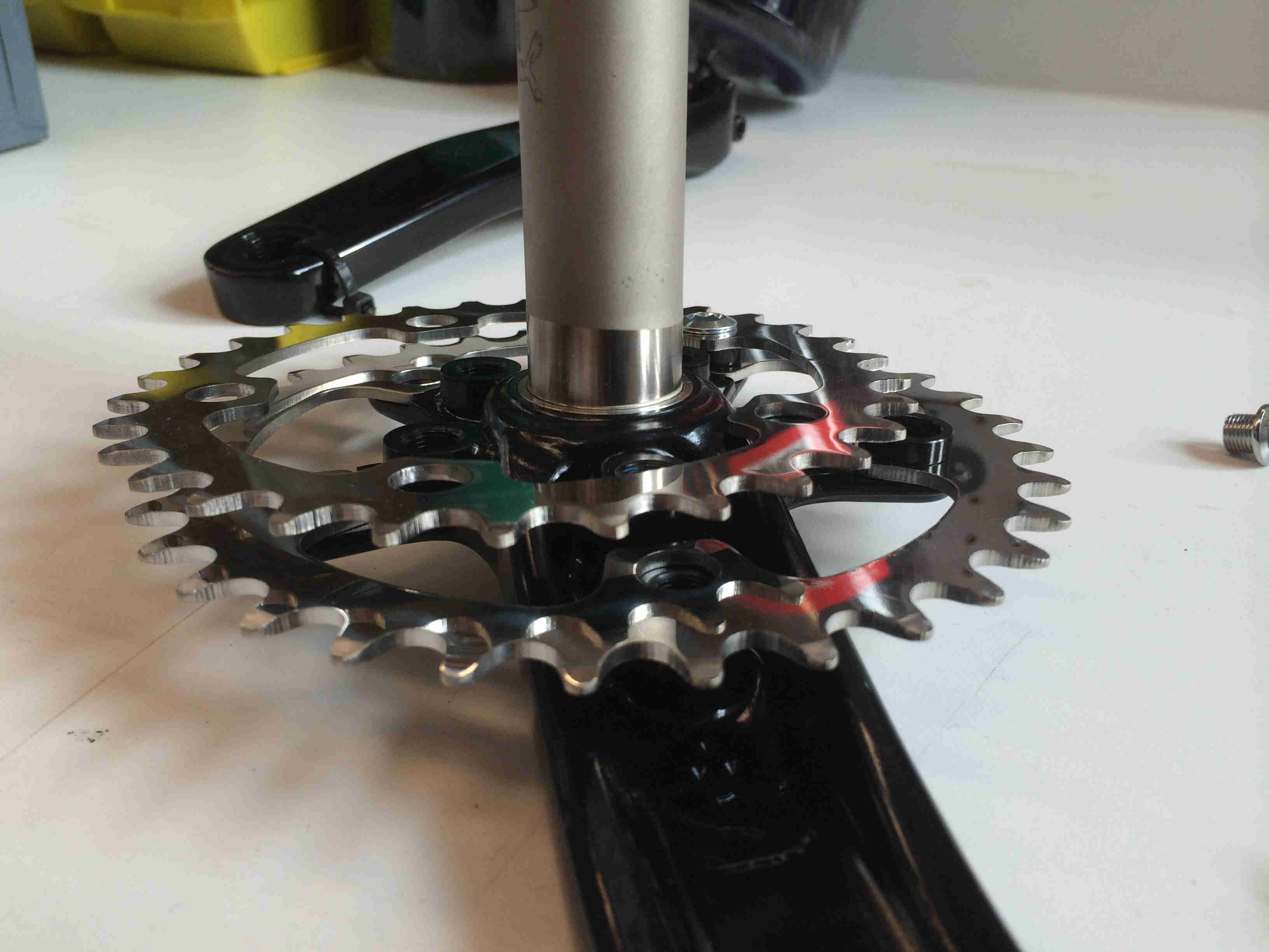 Side view of a Surly Bikes O.D Crankset, sitting on a table, showing chainring detail