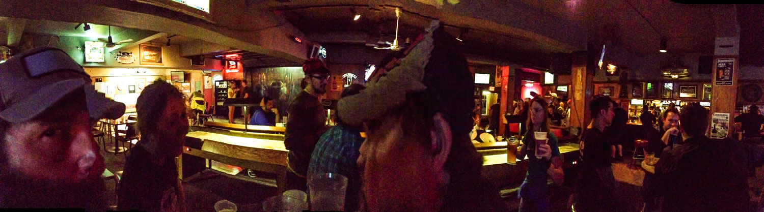 Panoramic view of people sitting at tables in a bar