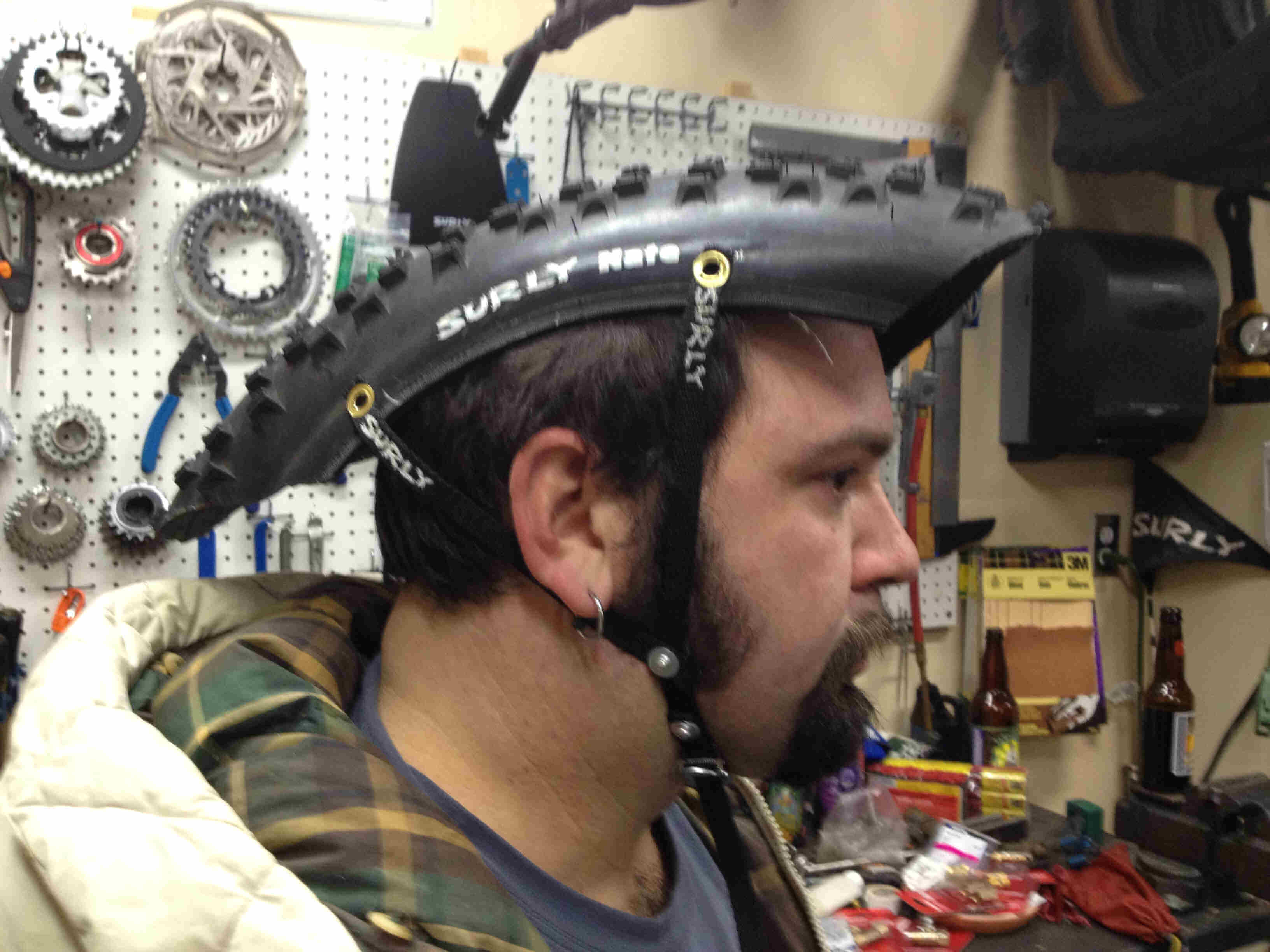 Right side view of a person wearing a helmet made from a cut out of a Surly fat bike tire