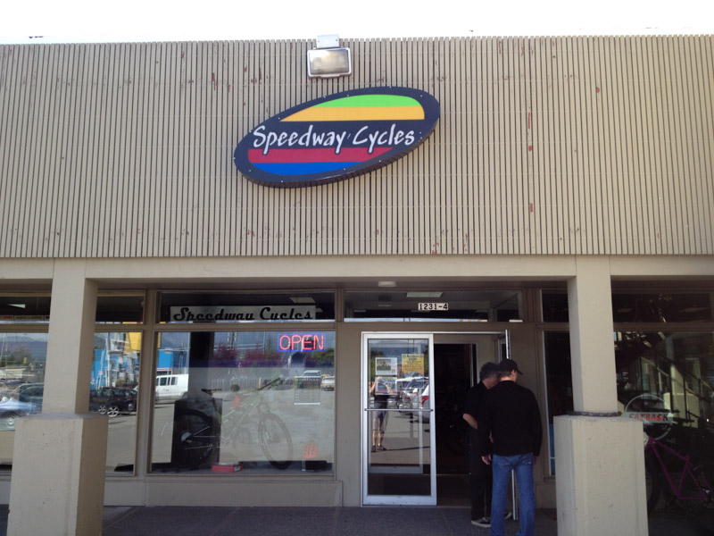 An outside view of a storefront, with a Speedway Cycles sign above