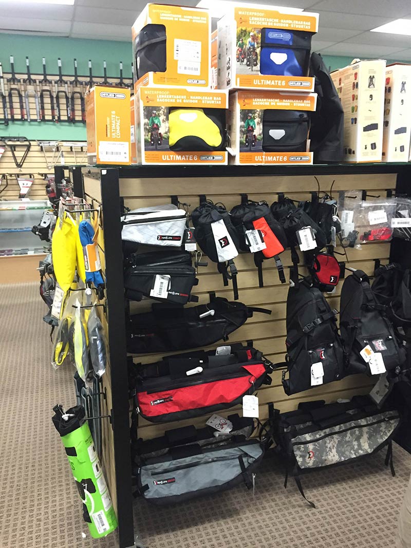 A rack of gear packs, on a retail product rack, in a bike shop