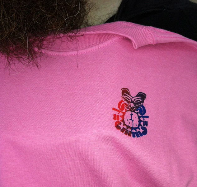 Downward view of a colored, silkscreen graphic on a pink t-shirt