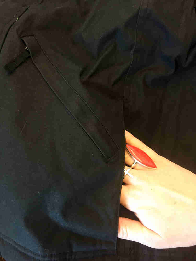 Cropped view of a hand reaching inside the pocket of a Surly Waxed Jacket 2.0