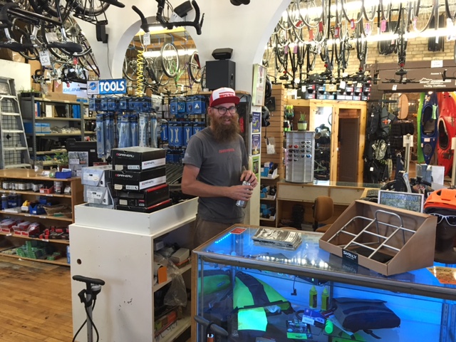 A person standing behind a service counter in a bike shop