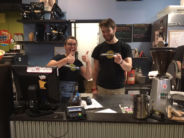 Two people behind a service counter at a bike shop