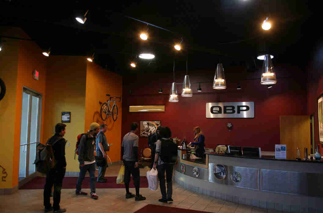 A group of people standing in the reception area of the QBP office