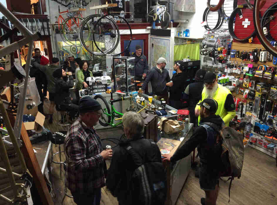 A downward view over a group of people in a bike shop