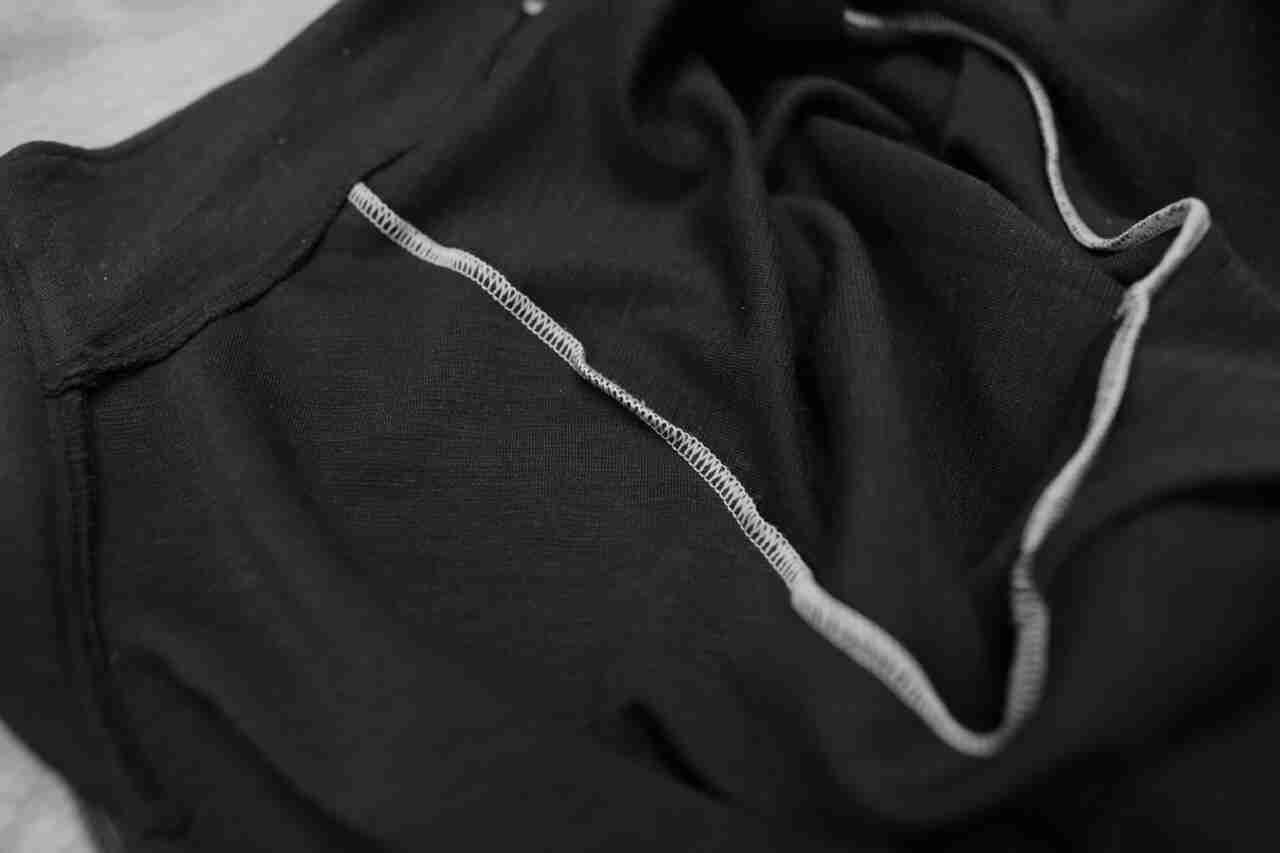 Downward view of the interior stitching detail from a Surly Bikes long sleeve biking jersey