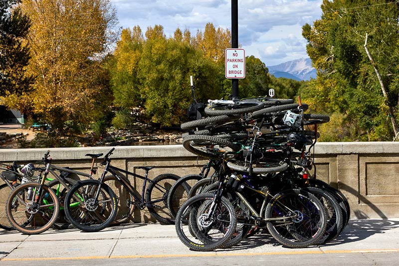 Bikes parked and piled high outstide