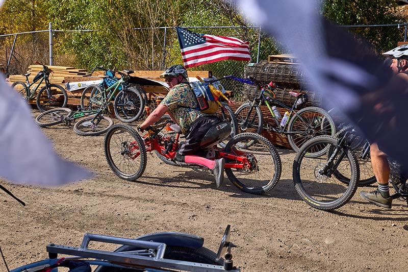 Adaptive cyclist on custom tricycle with American flag