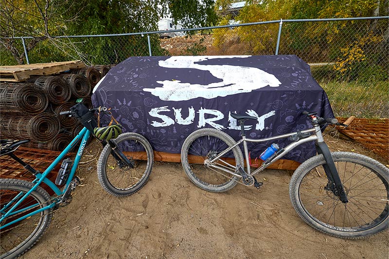 Surly banner with bike parked in lumber yard