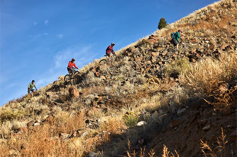 Single speeders climbing singletrack