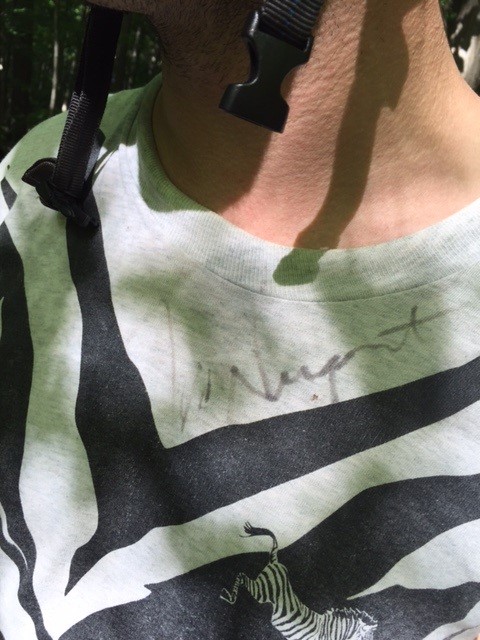 Close up of a person, wearing a t-shirt with a Ted Nugent autograph
