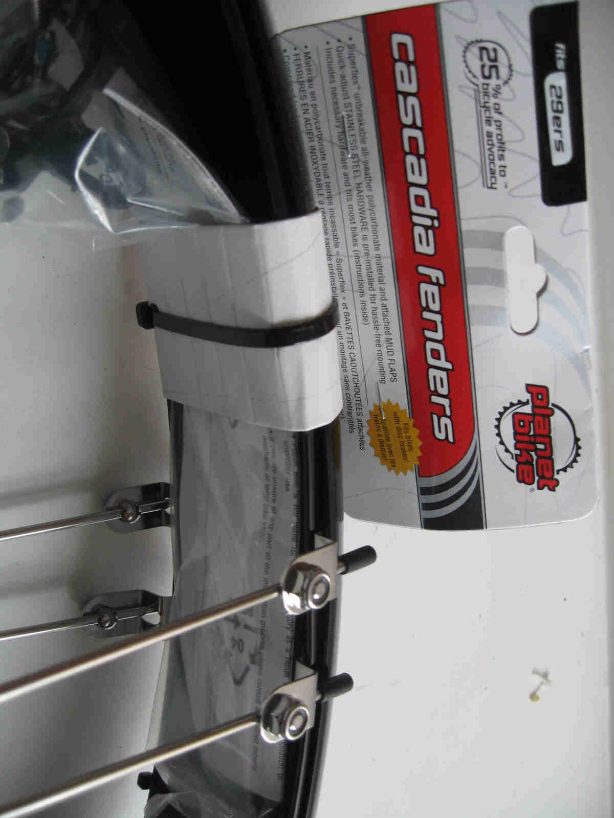 Retail package of Planet Bike fenders , sitting on a white surface