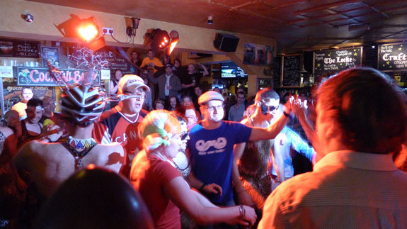 People dancing in a bar with spectators watching