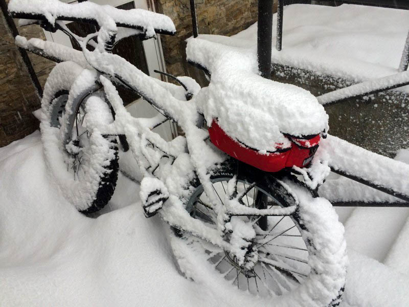 Downward left side view of a Surly Pug Ops bike covered in snow