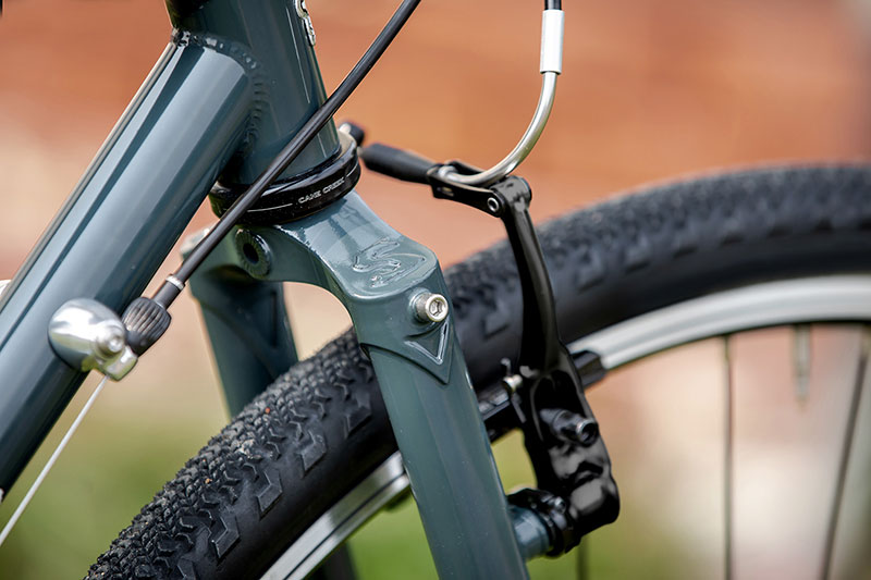 Close-up of front end of bike with rim brakes mounted on fork brake bosses