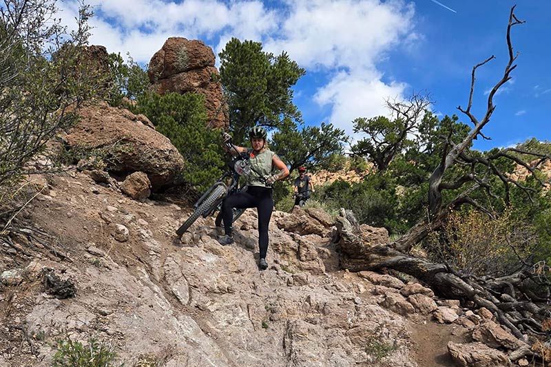 Rider walking down sketchy rocky decent