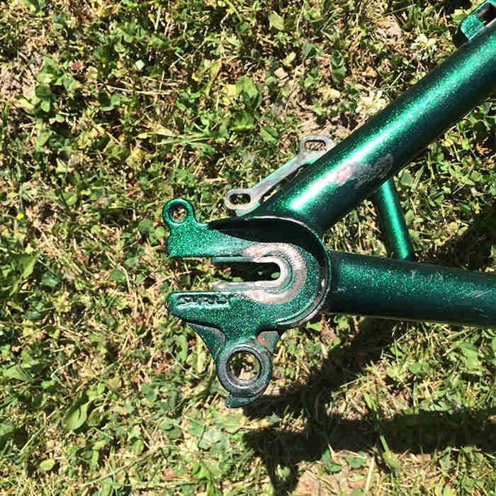 Close up view of the Karate Monkey drop outs on the frame of a Surly Krampus OPS bike, green