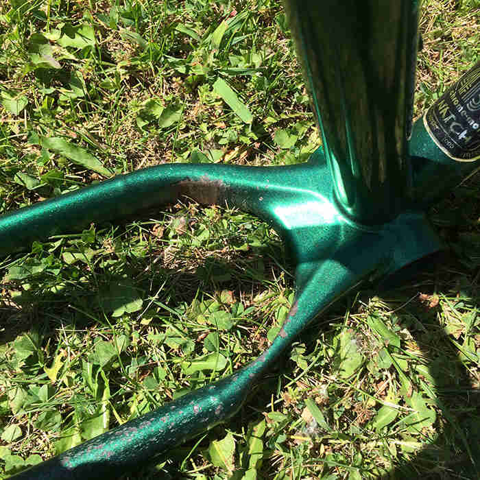 Downward zoomed in view of the one-piece cast chainstay yoke on a Surly Krampus bike frame, green