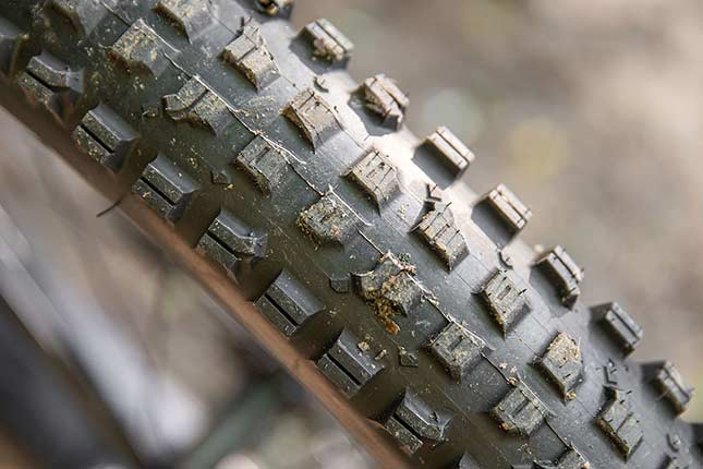 Close-up of Surly Dirt Wizard tire knobs, showing center tread and side lugs with siping which aid in traction