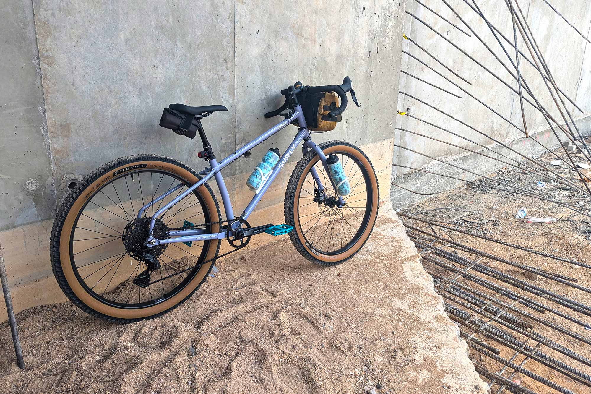 Surly Grappler Purple Dust Bunny color leaning against concrete wall