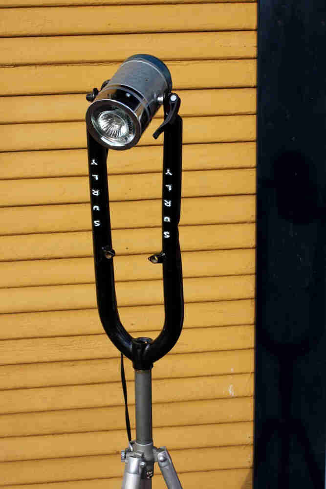 Front view of an upside down Surly fork with a halogen lamp mounted in the fork ends