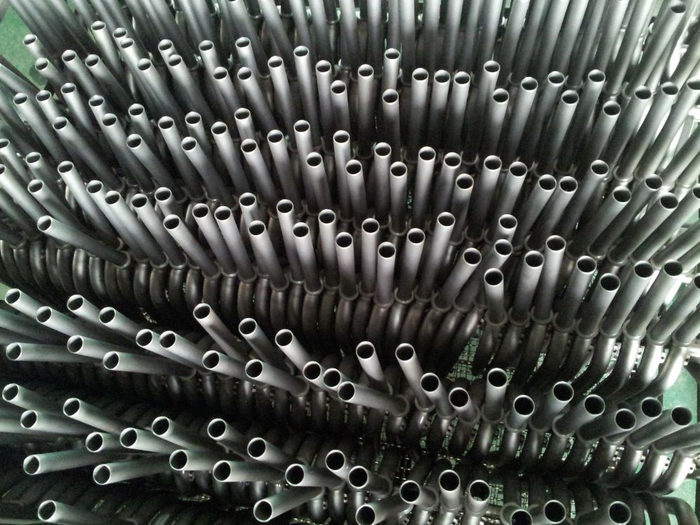 Downward view of manufactured Surly Krampus bike forks, in rows on a rack