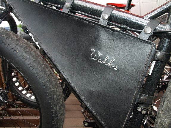 Close up, left side view of a custom leather frame bag that's mounted to a Surly fat bike
