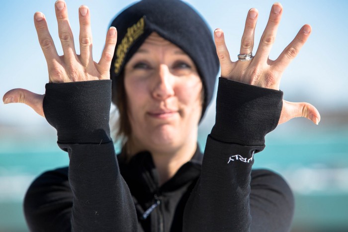 Front view of a person holding up their hands, palms in, showing the thumb hole detail on their Surly Long Sleeve Jersey