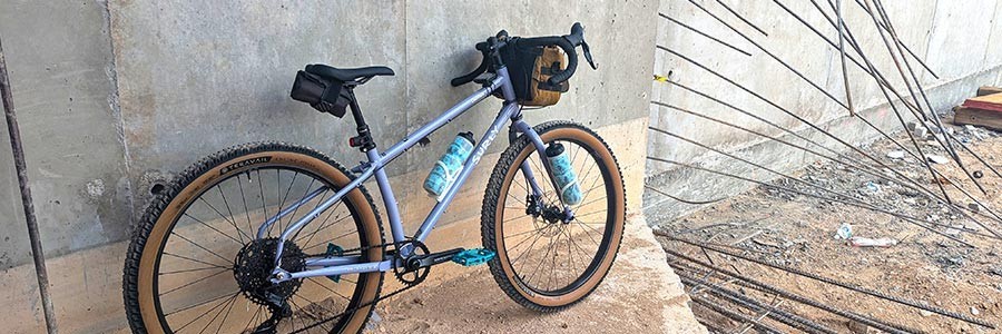 Surly Grappler Purple Dust Bunny color leaning against concrete wall