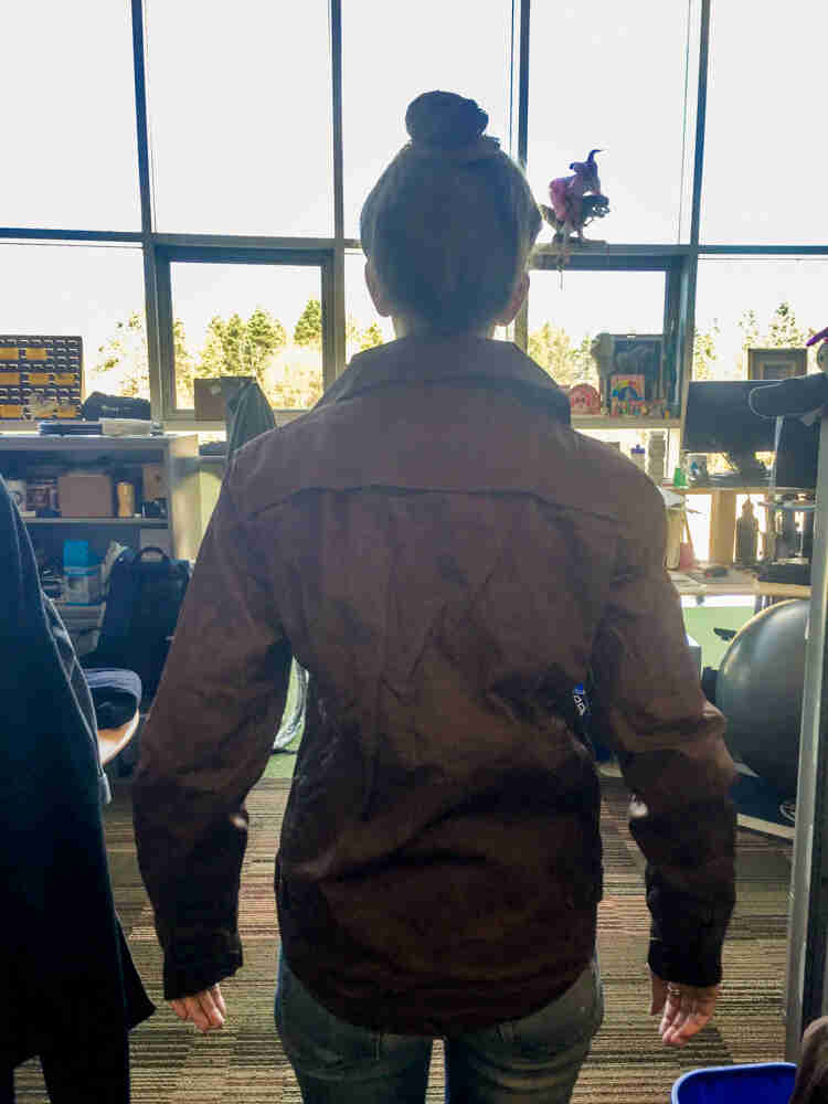 Rear view of Amy wearing the Surly Waxed Jacket 2.0