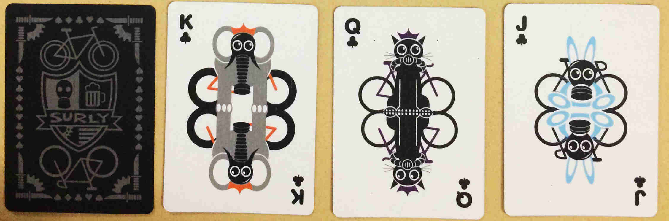 Downward view of two Surly playing cards - One face down and the other face up, showing a King of clubs