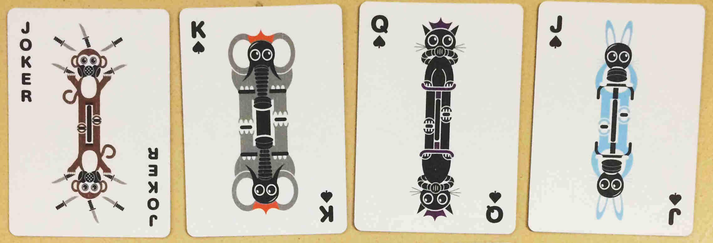 Downward view of two Surly playing cards - One is a Joker and the other a King of spades