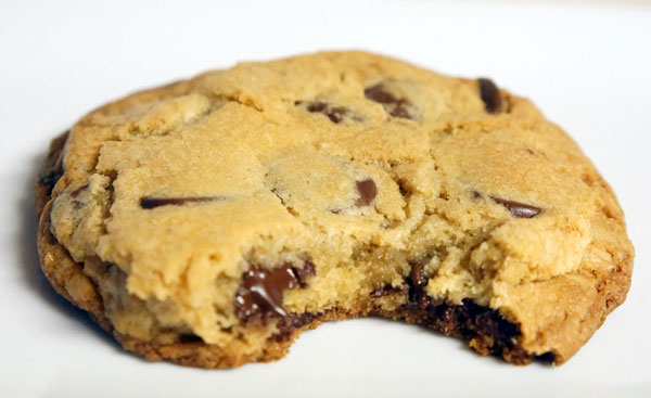 A chocolate cookie with a bite taken out