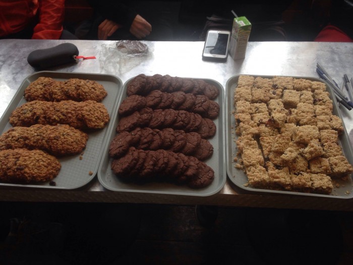 Downward view of 3 trays of baked goods on top of a table
