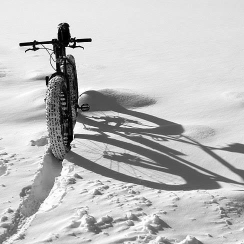 Front view of a Surly fat bike, parked in deep snow