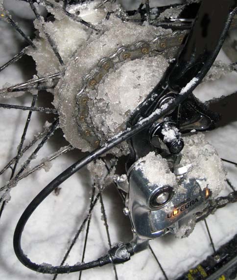 Right side, close up of the frozen cassette and derailleur on a black Surly bike