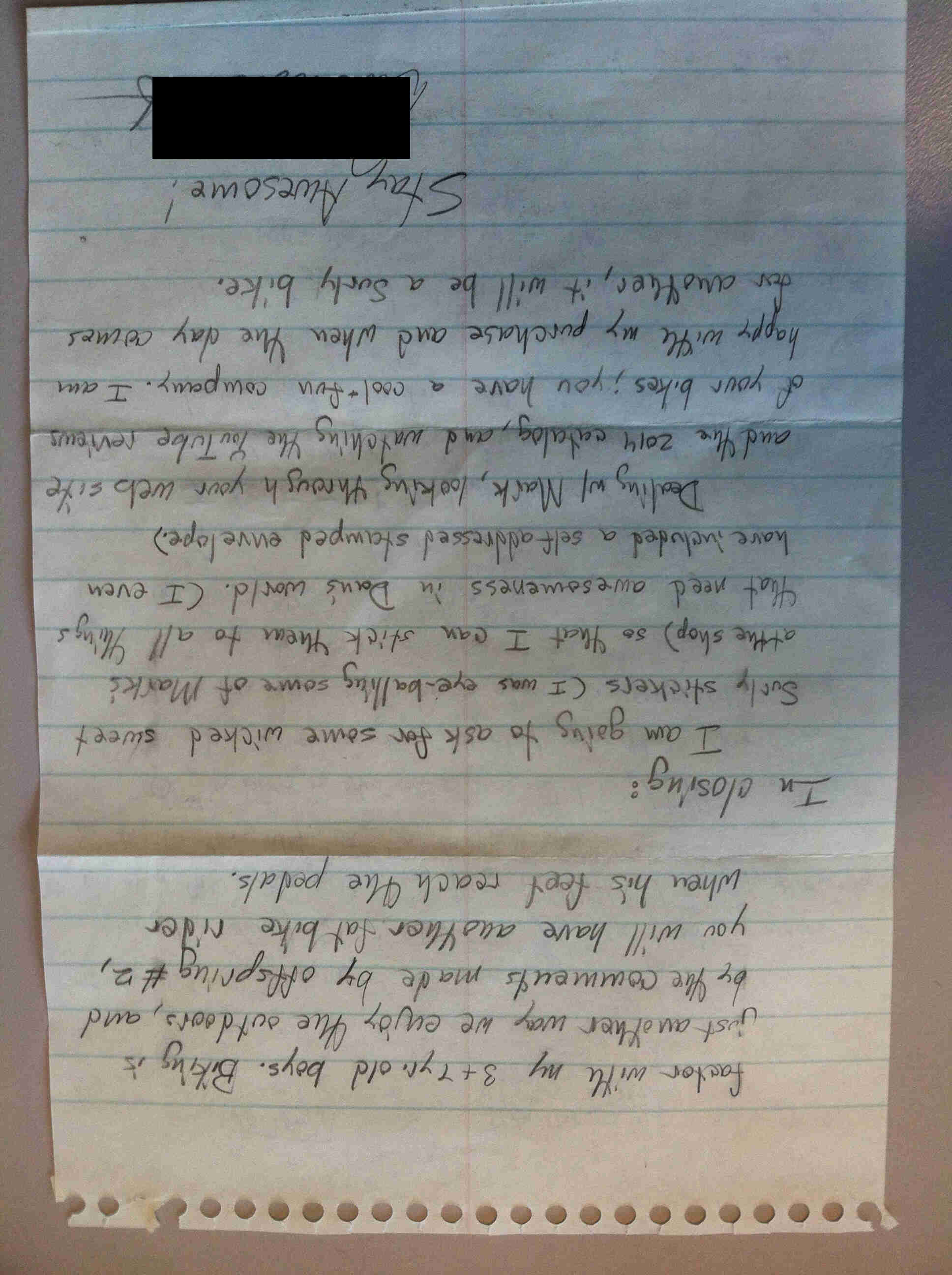 A upside down view of the back page of a letter, written on notebook paper in black pen