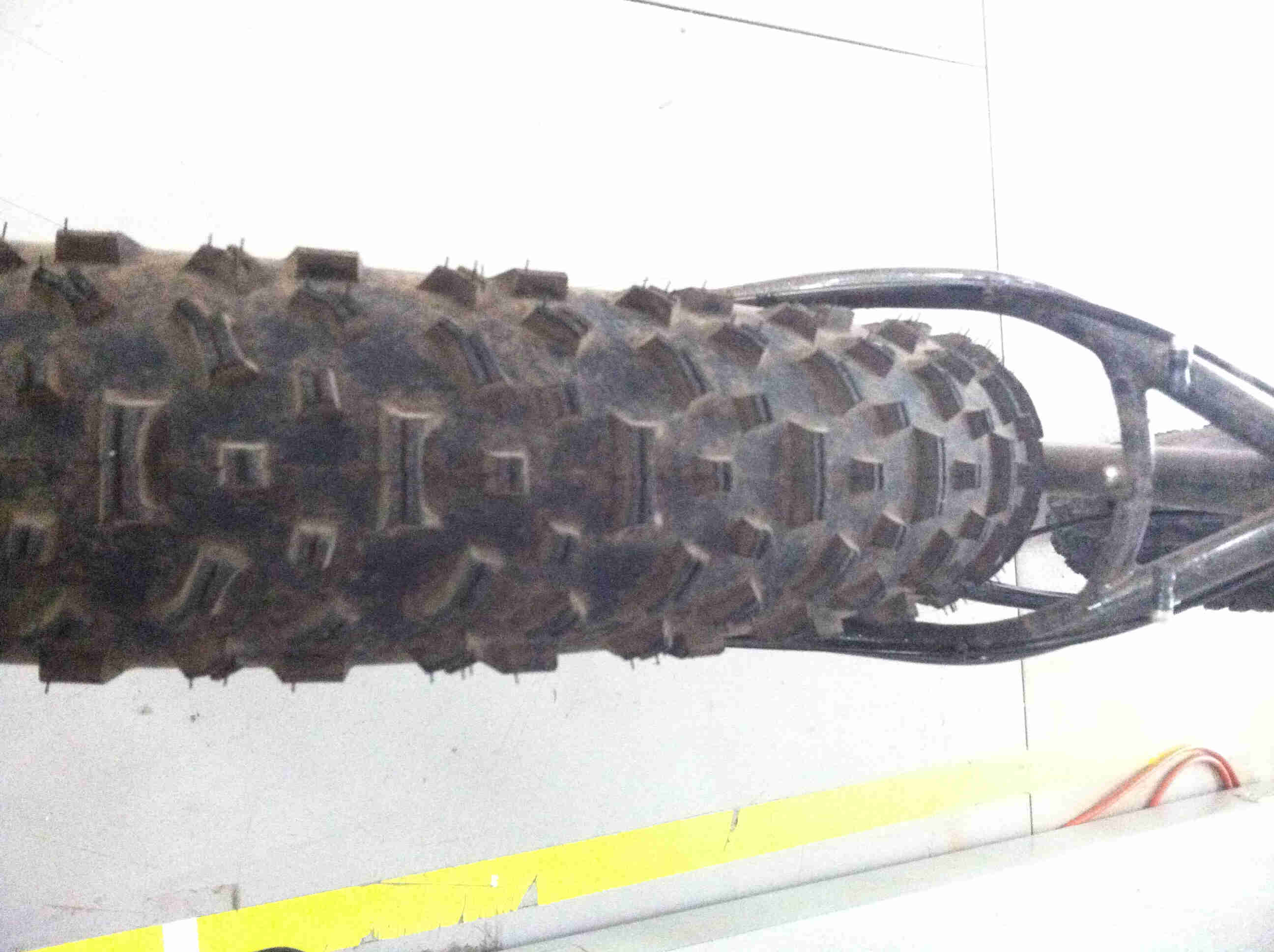 Rear, downward view of a rear wheel on a black Surly fat bike