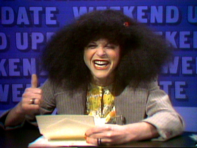 Front view of Rosanna Danna, from Saturday Night Live, giving a thumbs up
