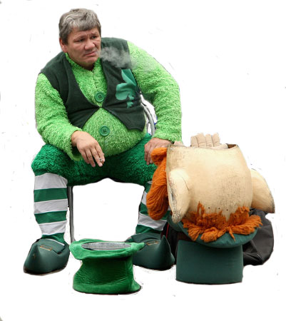 Front view of a person dressed in a leprechaun costume, smoking a cigarette, with a white background behind